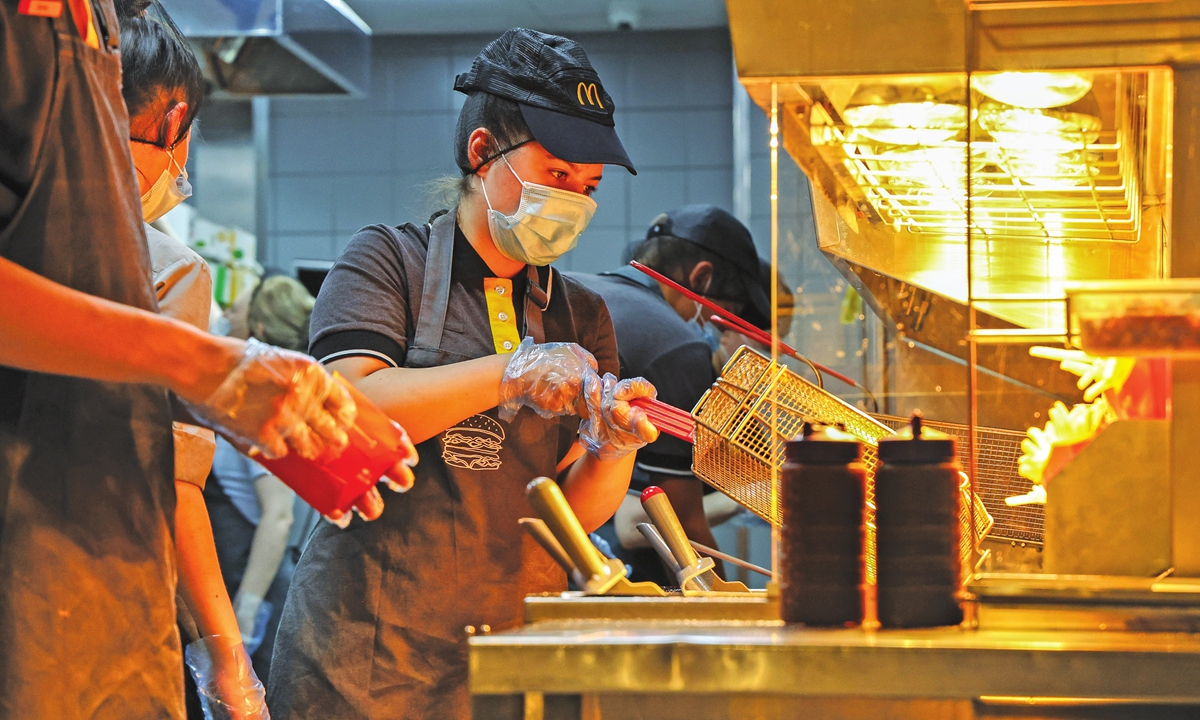 A worker cooks french fries in the kitchen inside a McDonald's restaurant in Moscow, Russia, on June 30, 2021. Photo: VCG