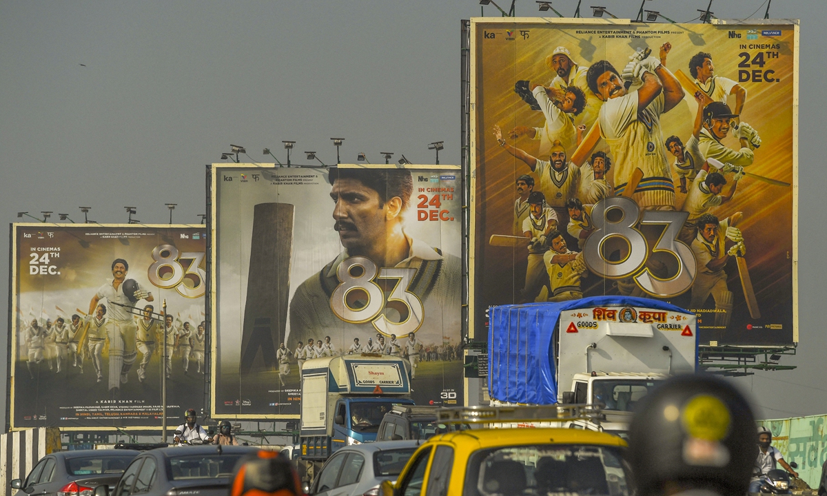 Vehicles move past billboards of Bollywood film 83, which is based on India's first cricket world cup victory in the year of 1983, in Mumbai on December 24, 2021.  Photo: AFP