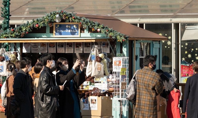 People visit a Christmas market at Yokohama Red Brick Warehouse in Yokohama, Japan, Dec. 24, 2021.Photo:Xinhua