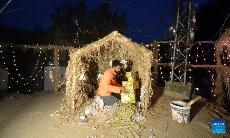 A man decorates a neighborhood on Christmas Eve in Islamabad, Pakistan, Dec. 24, 2021.(Xinhua/Ahmad Kamal)