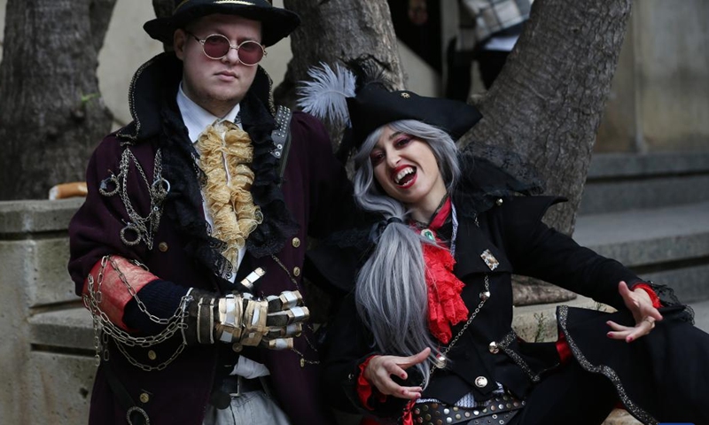 Performers in comic costumes pose for photos during the 13th Comic Strip International Festival in Algiers, Algeria, on Dec. 26, 2021. Photo:Xinhua