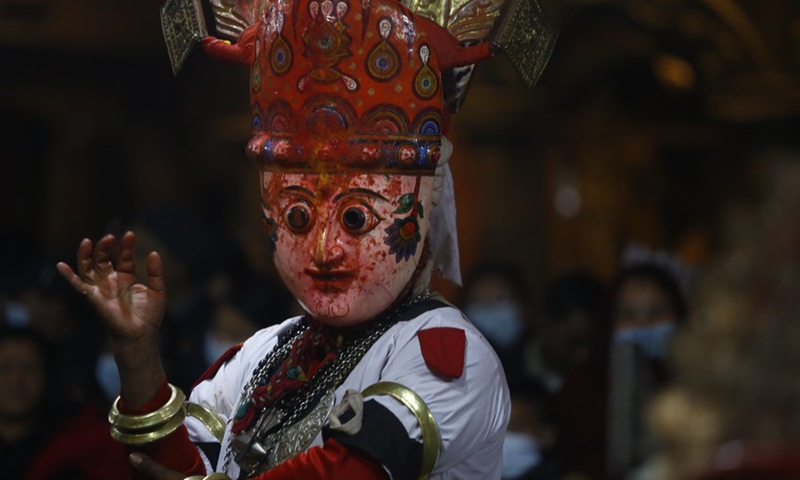 A masked man performs during the Navadurga Festival in Bhaktapur, Nepal, on Dec. 25, 2021.Photo:Xinhua