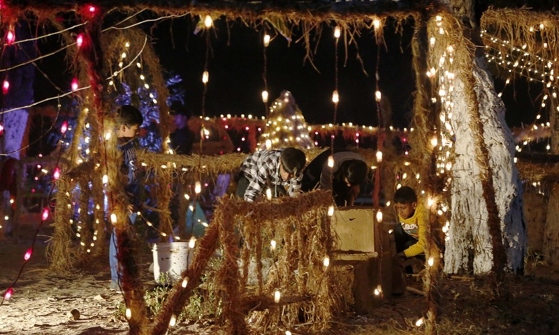 Boys decorate a neighborhood on Christmas Eve in Islamabad, capital of Pakistan on Dec. 24, 2021.Photo:Xinhua