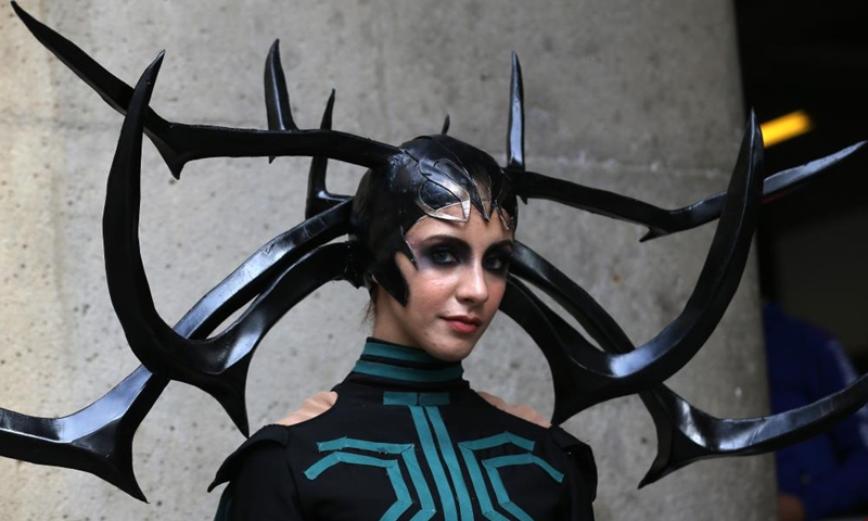 A performer in comic costumes poses for photos during the 13th Comic Strip International Festival in Algiers, Algeria, on Dec. 26, 2021.Photo:Xinhua