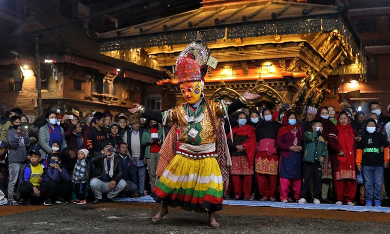 A masked man performs during the Navadurga Festival in Bhaktapur, Nepal, on Dec. 25, 2021.Photo:Xinhua