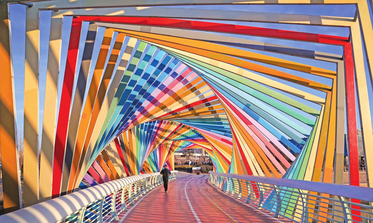 A resident walks on a rainbow bridge on Tuesday in Qingdao, East China's Shandong Province. Photo: IC
