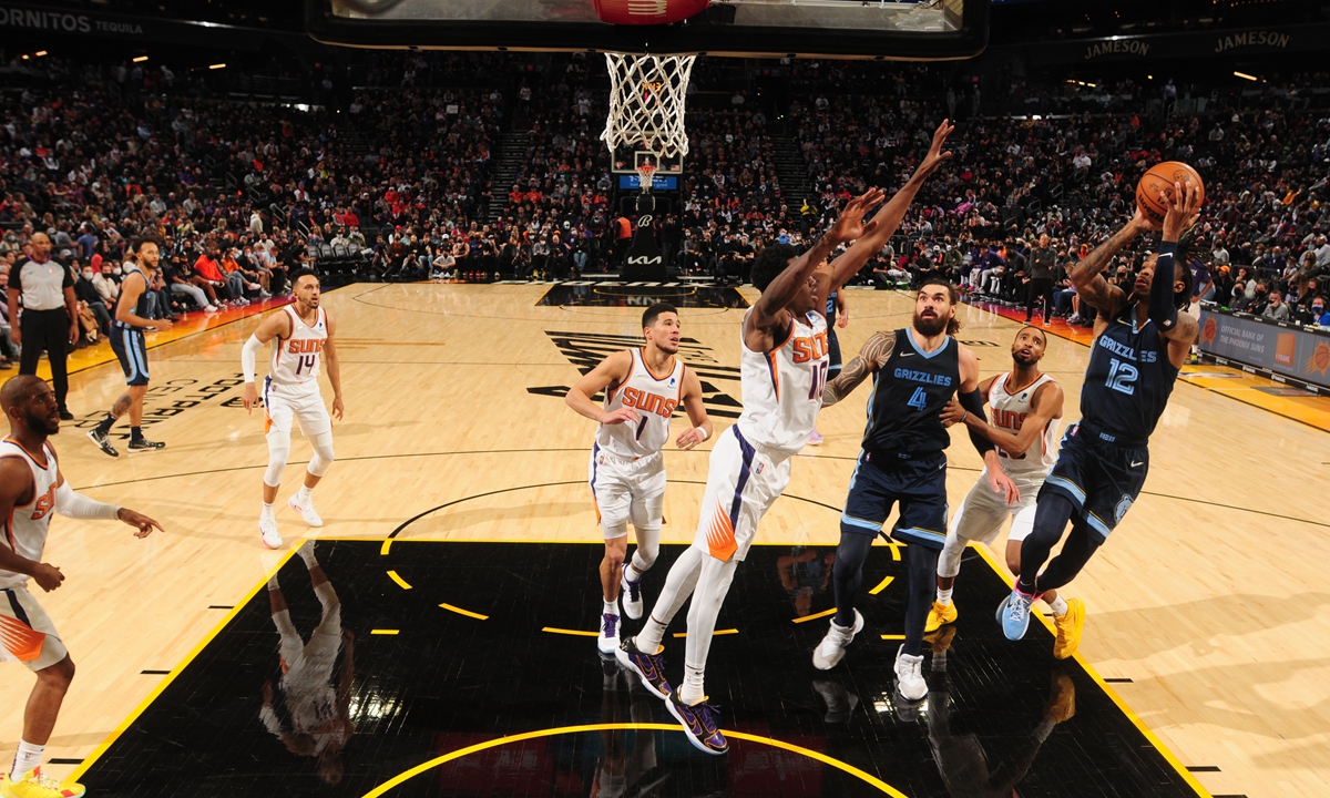 Ja Morant (right) of the Memphis Grizzlies shoots the ball against the Phoenix Suns on December 27, 2021 in Phoenix, Arizona. Photo: VCG