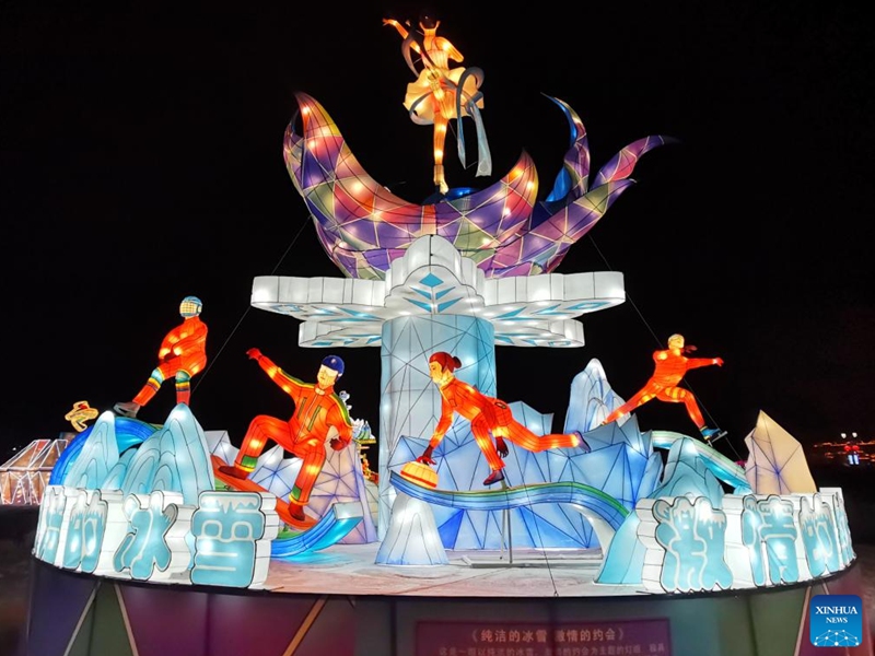 Colorful lanterns themed on winter sports are displayed at Binhu Park in Laiyuan County, north China's Hebei Province, Dec. 27, 2021. (Photo by Li Hui/Xinhua)