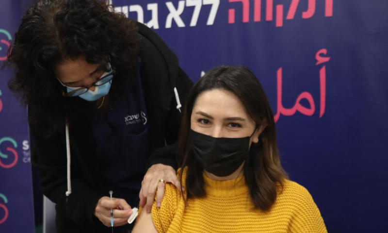 An Israeli woman receives the fourth dose of COVID-19 vaccine at Sheba Medical Center in central Israeli city of Ramat Gan on Dec. 28, 2021. Israel began trials of a fourth dose of coronavirus vaccine on Monday. (Gideon Markowicz/JINI via Xinhua)