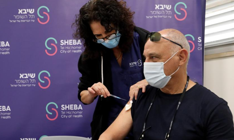 An Israeli man receives the fourth dose of COVID-19 vaccine at Sheba Medical Center in central Israeli city of Ramat Gan on Dec. 28, 2021. Israel began trials of a fourth dose of coronavirus vaccine on Monday. (Photo by Gil Cohen Magen/Xinhua)