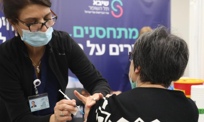 An Israeli woman receives the fourth dose of COVID-19 vaccine at Sheba Medical Center in central Israeli city of Ramat Gan on Dec. 28, 2021. Israel began trials of a fourth dose of coronavirus vaccine on Monday. (Gideon Markowicz/JINI via Xinhua)