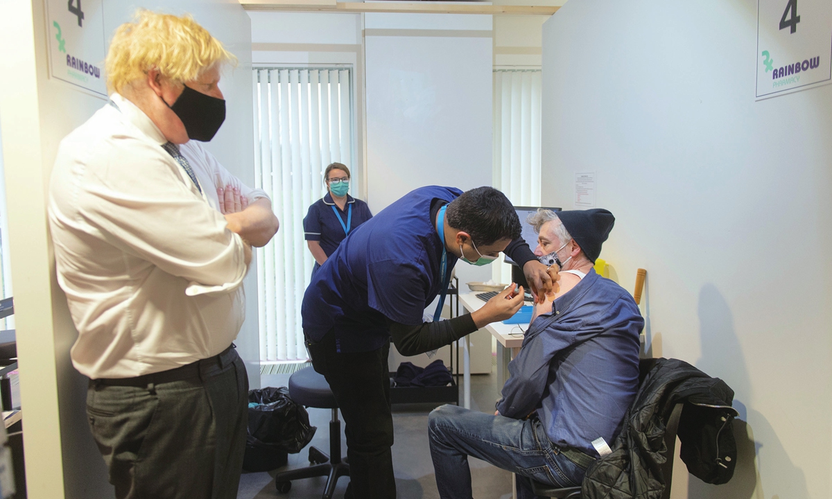 UK Prime Minister Boris Johnson visits a COVID-19 vaccination center on December 29, 2021 in Milton Keynes, England. Some 45.2 percent of the UK population have received either a third vaccine or booster shot as of Christmas week. The UK reported more than 128,600 COVID-19 infections on December 28. The country has recorded over 12.3 million cases in total. 