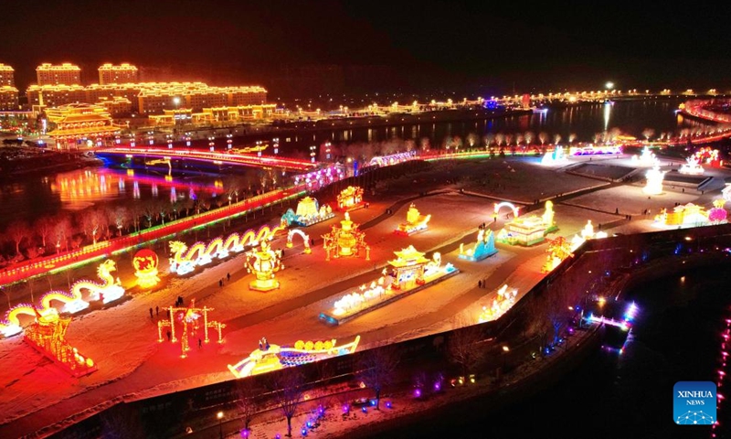 Colorful lanterns themed on winter sports are displayed at Binhu Park in Laiyuan County, north China's Hebei Province, Dec. 27, 2021. (Photo by Li Hui/Xinhua)
