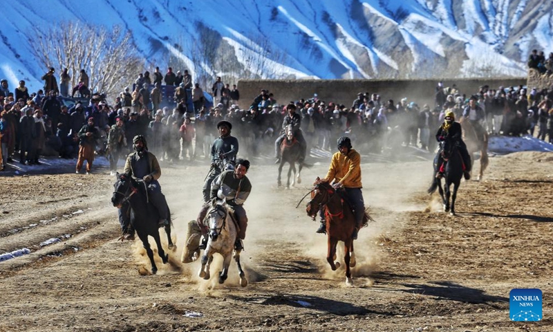 Horse riders compete during a game of Buzkashi, or goat grabbing in English, in Bamiyan, Afghanistan, Dec. 28, 2021. (Photo by Ahmadi/Xinhua)