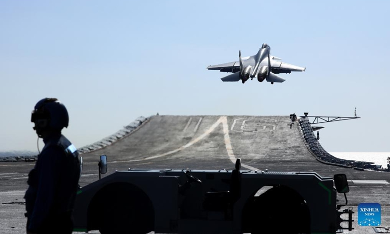 Undated file photo shows a carrier-based J-15 fighter jet taking off during open-sea combat training.Photo:Xinhua
