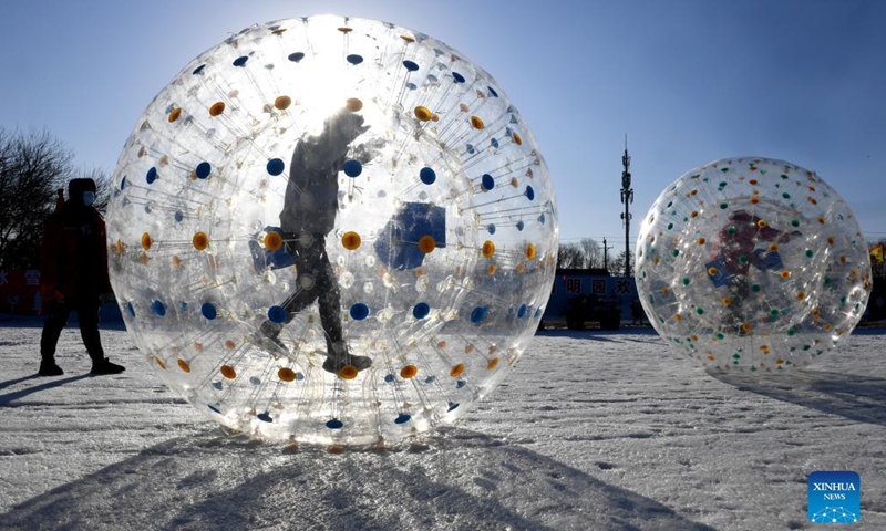 Visitors have fun inside air balloons on snowfield at Yuanmingyuan Park in Beijing, capital of China, Dec. 30, 2021.Photo:Xinhua