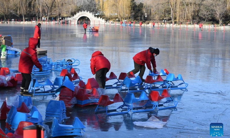 Staff members prepare sleds on a frozen lake at Yuanmingyuan Park in Beijing, capital of China, Dec. 30, 2021.Photo:Xinhua
