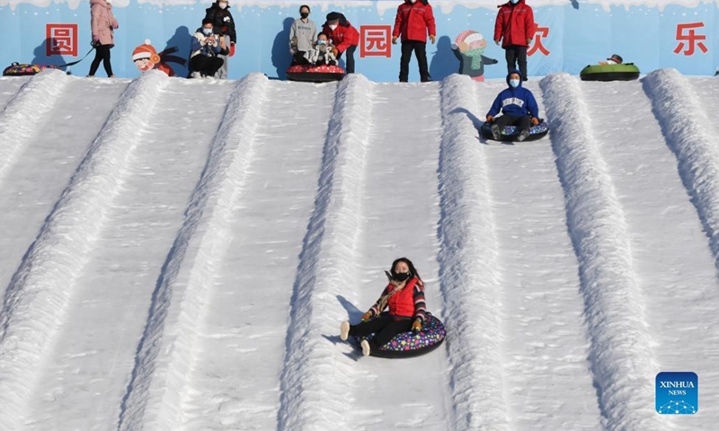 Visitors experience snow tubes at Yuanmingyuan Park in Beijing, capital of China, Dec. 30, 2021.Photo:Xinhua