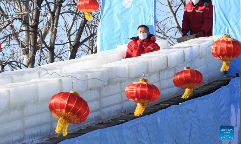 Staff members test an ice slide at Yuanmingyuan Park in Beijing, capital of China, Dec. 30, 2021.Photo:Xinhua