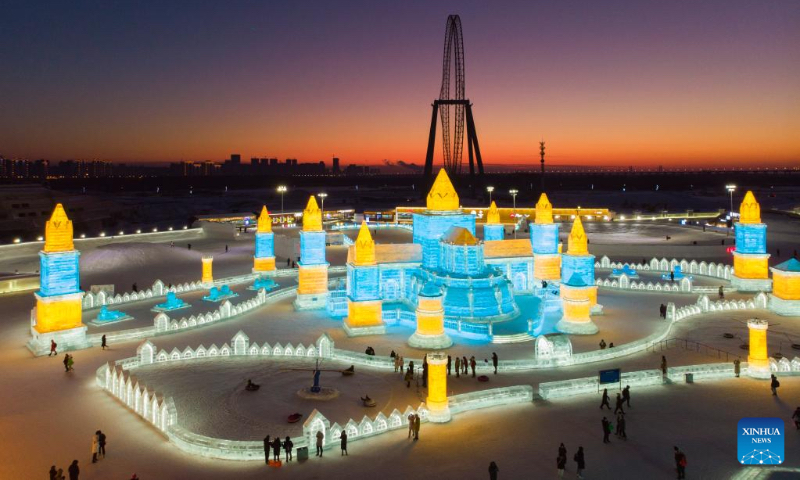Aerial photo taken on Jan. 2, 2022 shows tourists visiting the Harbin Ice-Snow World in Harbin, northeast China's Heilongjiang Province. Harbin, famous for its ice and snow tourism, attracts tourists during the winter time. (Xinhua/Zhang Tao)