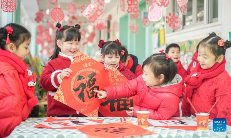 Children present Chinese character Fu, which means good fortune, at a kindergarten in Changxing County of Huzhou City, east China's Zhejiang Province, Dec. 31, 2021.Photo:Xinhua