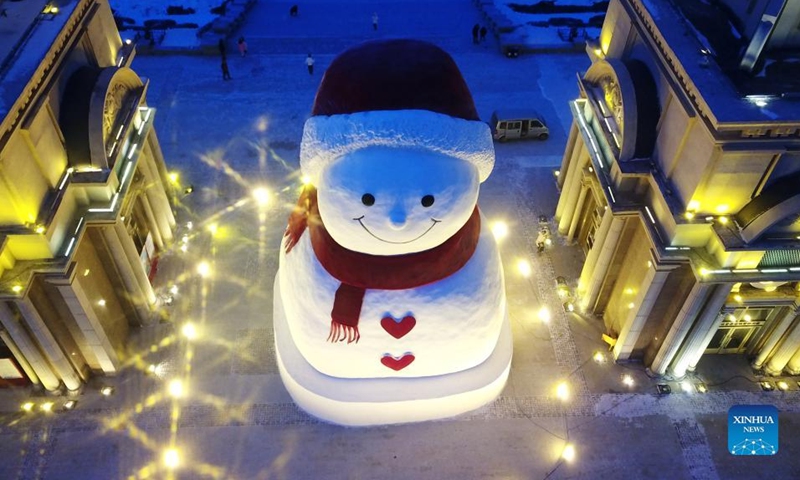 Aerial photo taken on Jan. 9, 2022 shows a huge snowman on the riverbank of Songhua River in Harbin, capital of northeast China's Heilongjiang Province. The giant snowman is about 18 meters tall and 13 meters wide, using more than 2,000 cubic meters of snow. (Xinhua/Wang Jianwei)