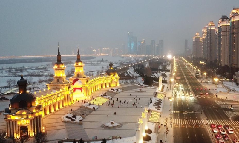 Aerial photo taken on Jan. 9, 2022 shows a huge snowman on the riverbank of Songhua River in Harbin, capital of northeast China's Heilongjiang Province. The giant snowman is about 18 meters tall and 13 meters wide, using more than 2,000 cubic meters of snow. (Xinhua/Wang Jianwei)