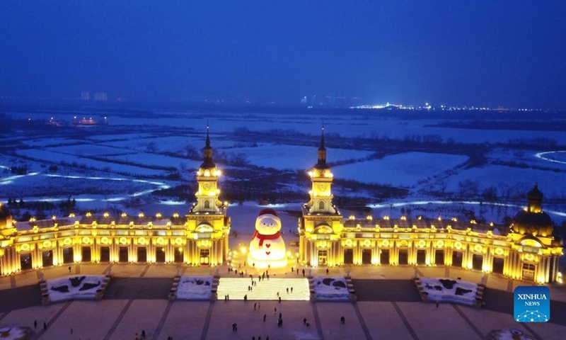 Aerial photo taken on Jan. 9, 2022 shows a huge snowman on the riverbank of Songhua River in Harbin, capital of northeast China's Heilongjiang Province. The giant snowman is about 18 meters tall and 13 meters wide, using more than 2,000 cubic meters of snow. (Xinhua/Wang Jianwei)