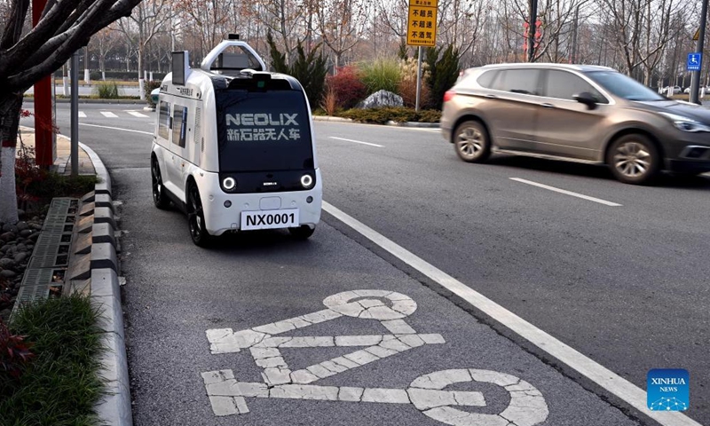 An unmanned delivery vehicle runs on a bicycle lane in Xi'an, capital of northwest China's Shaanxi Province, Jan. 9, 2022. The driverless vehicle is designed to transport goods with a maximum weight of 320 kg per trip. It can traverse 6.5 km through the lanes on roads on a single trip. (Xinhua/Tao Ming) 