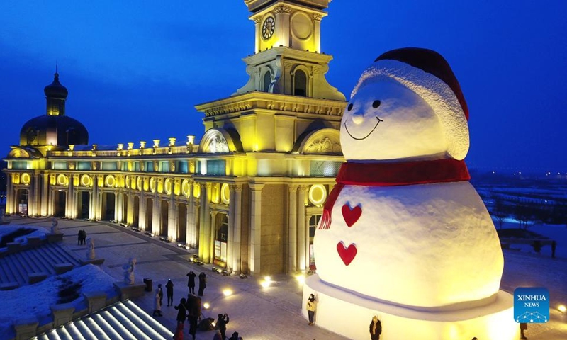 Aerial photo taken on Jan. 9, 2022 shows a huge snowman on the riverbank of Songhua River in Harbin, capital of northeast China's Heilongjiang Province. The giant snowman is about 18 meters tall and 13 meters wide, using more than 2,000 cubic meters of snow. (Xinhua/Wang Jianwei)