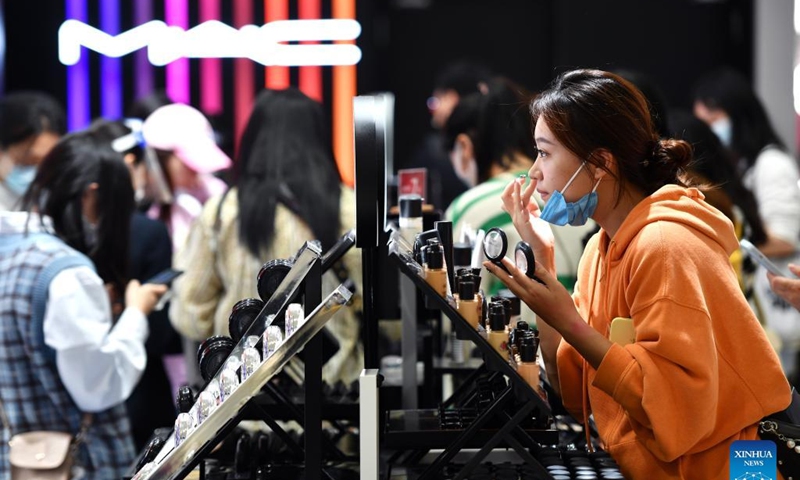 A customer tries cosmetic products in a duty-free shop in Haikou, capital of south China's Hainan Province, Jan. 3, 2022.Photo: Xinhua 