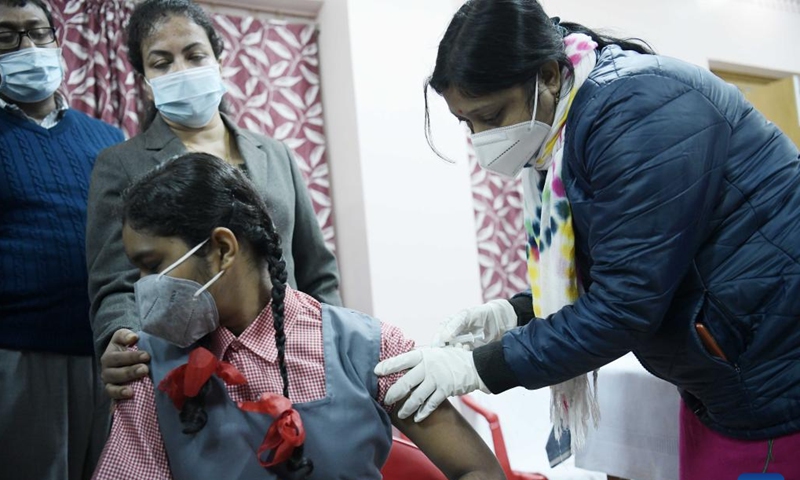 A girl receives a dose of COVID-19 vaccine in Agartala, the capital city of India's northeastern state of Tripura, Jan. 3, 2022.Photo:Xinhua