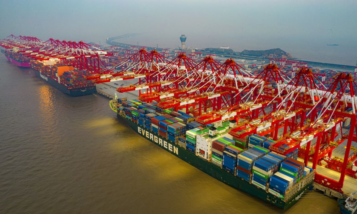 Container vessels berth at the Port of Yangshan to clear cargo around the clock in Shanghai on January 2, 2022. In 2021, the Port of Shanghai handled over 47 million standard containers, ranking first among the world's ports for the 12th consecutive year. Photo: VCG