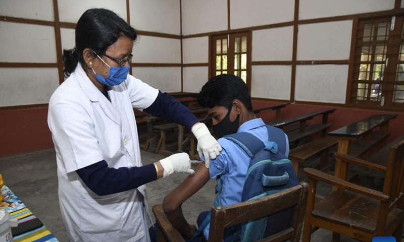 A boy receives a dose of COVID-19 vaccine at a school in Nagaon district of India's northeastern state of Assam, Jan. 3, 2022.Photo:Xinhua