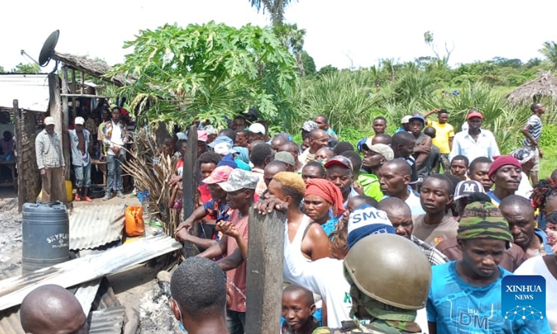 People gather around a house torched in an attack at a village in Lamu, Kenya, on Jan. 3, 2022. At least six villagers were killed on Monday in an attack by al-Shabab militants at a village in Kenya's coastal county of Lamu, local officials said.(Photo: Xinhua)