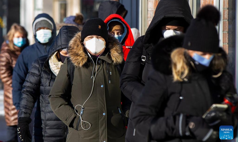 People with a thick coats line up to enter a COVID-19 vaccination clinic in Toronto, Canada, on Jan. 3, 2022. The City of Toronto issued an extreme cold weather alert on Monday.(Photo: Xinhua)