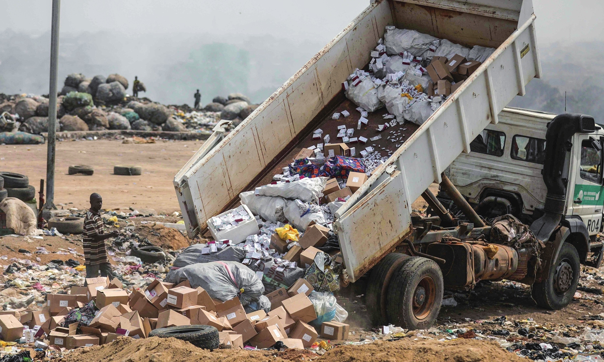 A truck offloads expired AstraZeneca COVID-19 vaccines at the Gosa dump site in Abuja, Nigeria on December 22, 2021. Photo: VCG