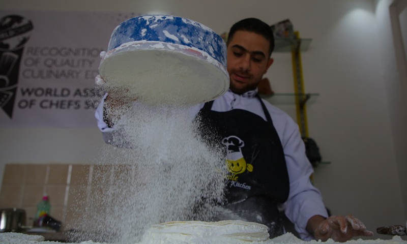 A Palestinian chef teaches a group of Palestinian interns about professional food production and service at Gaza City's first-ever culinary school, Jan. 2, 2022 (Photo: Xinhua)