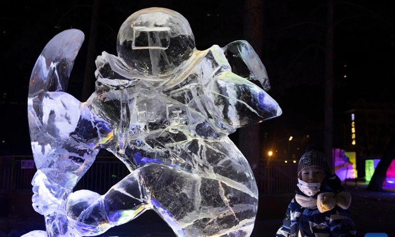 A child has fun at the 48th Harbin ice lantern fair in Harbin, northeast China's Heilongjiang Province, Jan. 5, 2022. The ice lantern fair kicked off here on Wednesday(Photo: Xinhua)
