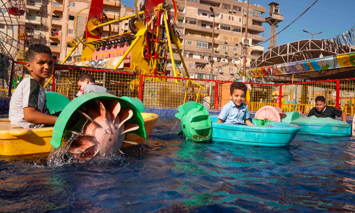 Egyptian children enjoy a water park in commercial city el-Mahalla el-Kubra, Egypt on July 20, 2021. Photo: AFP