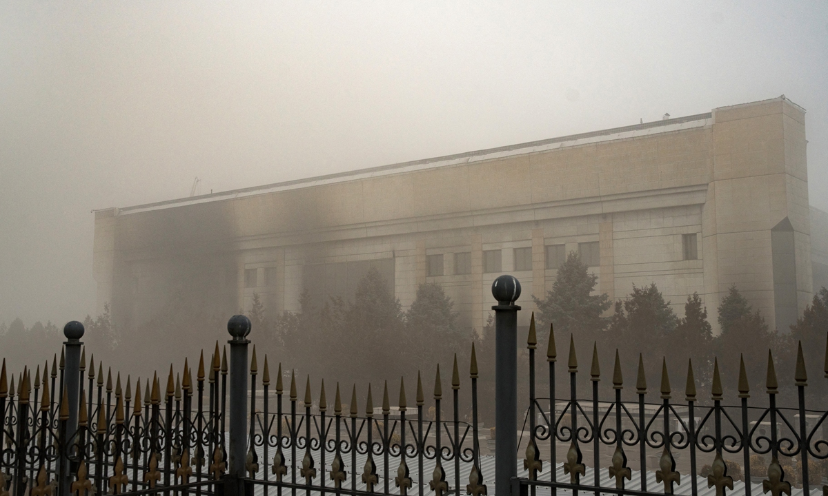 A burned-out administrative building is seen behind a fence in central Almaty on January 6, 2022.Photo: AFP