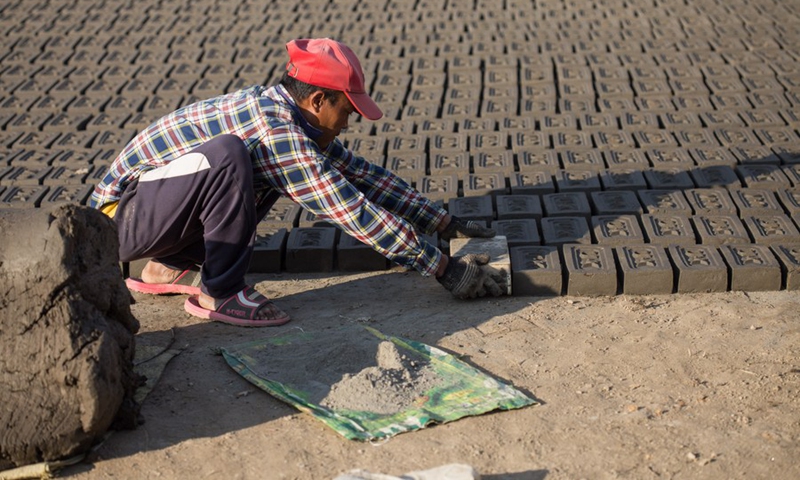 A worker makes bricks at a brick factory in Lalitpur, Nepal, on Jan. 4, 2022.(Photo: Xinhua)