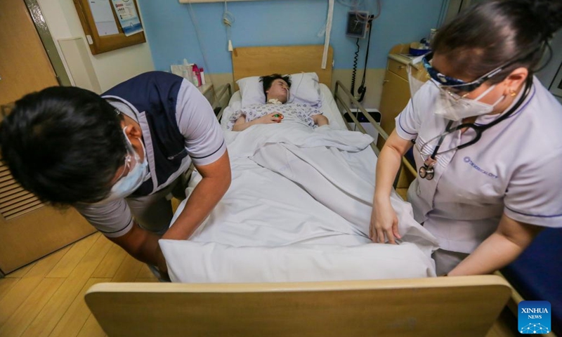 Nursing workers take care of Li Jinxin, a 26-year-old Chinese woman, at the Medical City hospital in Pasig City, the Philippines, Dec. 13, 2021. Li Jinxin has found her dream of returning home come true after battling a devastating illness for almost two and a half years in the Philippines that nearly cost her life.(Photo: Xinhua)
