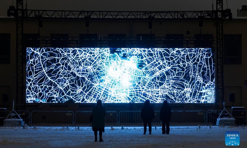 People enjoy a light show during the Lux Helsinki light festival in Helsinki, Finland, Jan. 5, 2022. Lux Helsinki is an annual festival of light art that spreads across downtown Helsinki in early January. Everyone may enjoy the display free of charge.Photo:Xinhua
