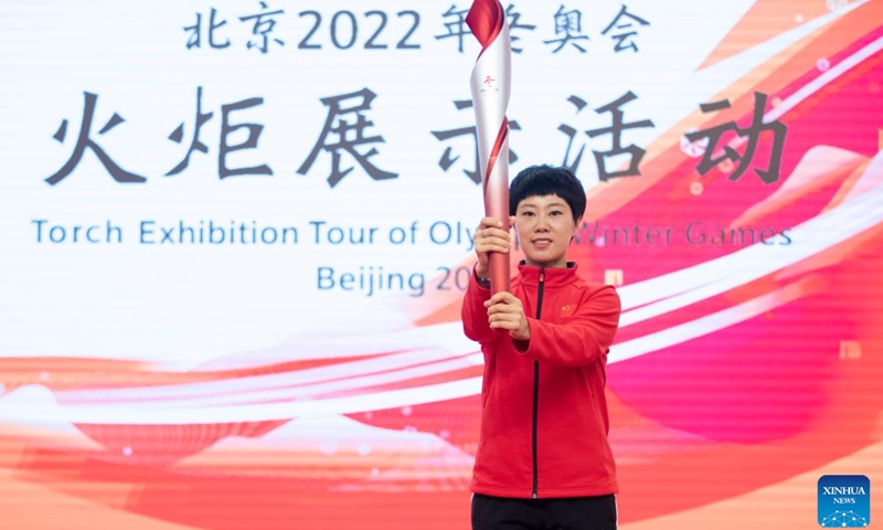 Short track speed skating Olympic champion Zhang Hui holds the torch during the Torch Exhibition Tour of Olympic Winter Games Beijing 2022 in Harbin, northeast China's Heilongjiang Province, Jan. 5, 2022.Photo:Xinhua