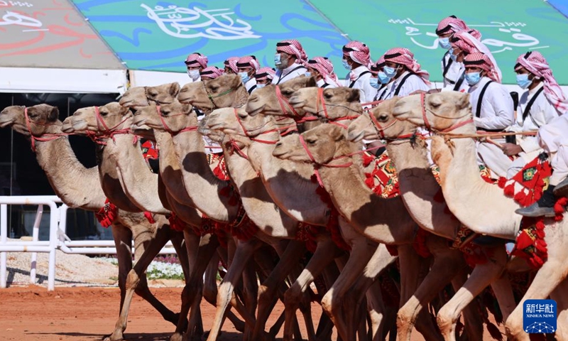 People ride camels for a parade during the King Abdulaziz Camel Festival in north of Riyadh, Saudi Arabia, on Jan. 5, 2022. The festival kicked off here on Dec. 1, 2021, with the participation of about 33,000 camel owners.Photo:Xinhua