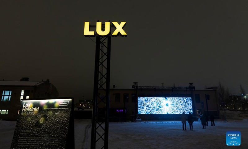 People enjoy a light show during the Lux Helsinki light festival in Helsinki, Finland, Jan. 5, 2022. Lux Helsinki is an annual festival of light art that spreads across downtown Helsinki in early January. Everyone may enjoy the display free of charge.Photo:Xinhua