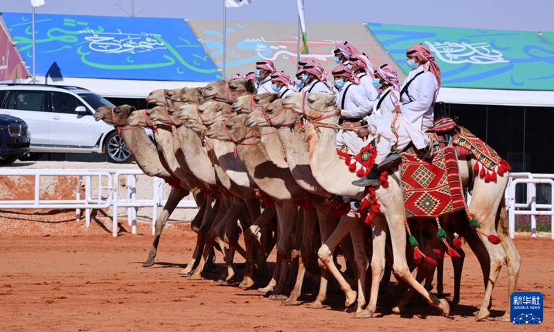 People ride camels for a parade during the King Abdulaziz Camel Festival in north of Riyadh, Saudi Arabia, on Jan. 5, 2022. The festival kicked off here on Dec. 1, 2021, with the participation of about 33,000 camel owners.Photo:Xinhua