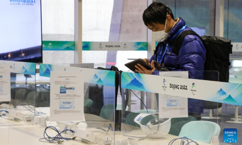 A journalist checks information in the Press Workroom of Main Media Center for the 2022 Olympic and Paralympic Winter Games in Beijing, capital of China, Jan. 10, 2022. (Xinhua/Xu Zijian)