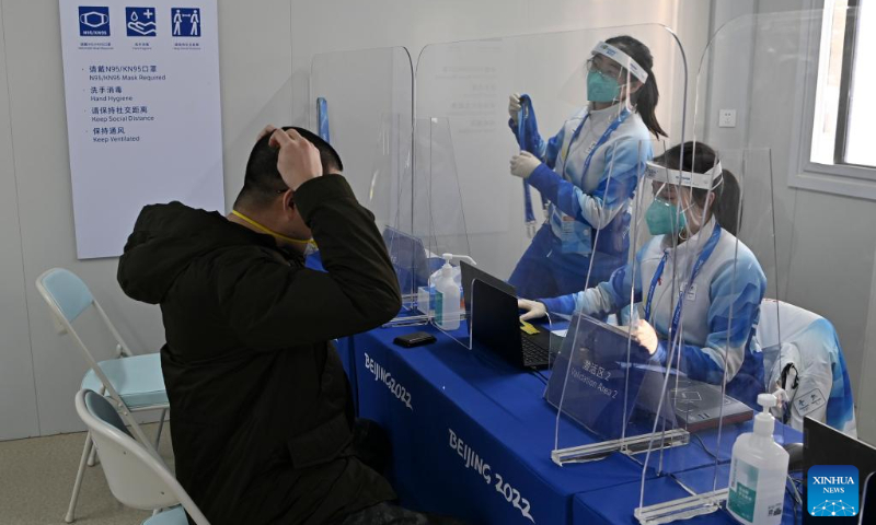 A journalist gets his certificate activated at the validation area of the Main Media Center for the 2022 Olympic and Paralympic Winter Games in Beijing, capital of China, Jan. 10, 2022. (Xinhua/He Changshan)